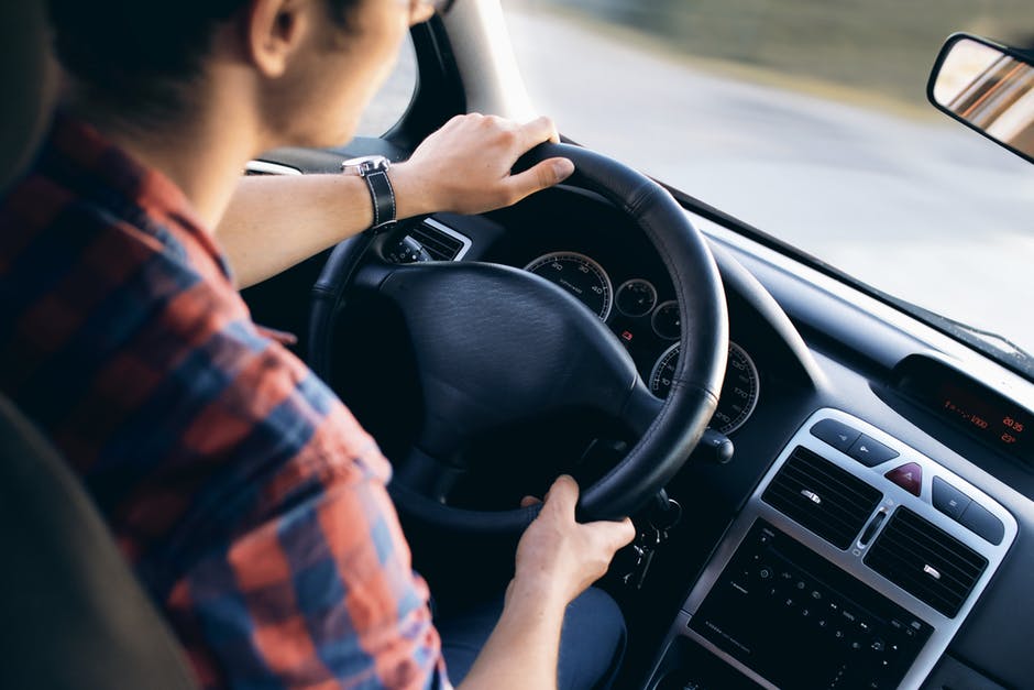 man driving car