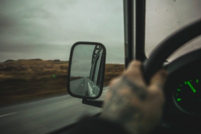 car driver looking in side mirror