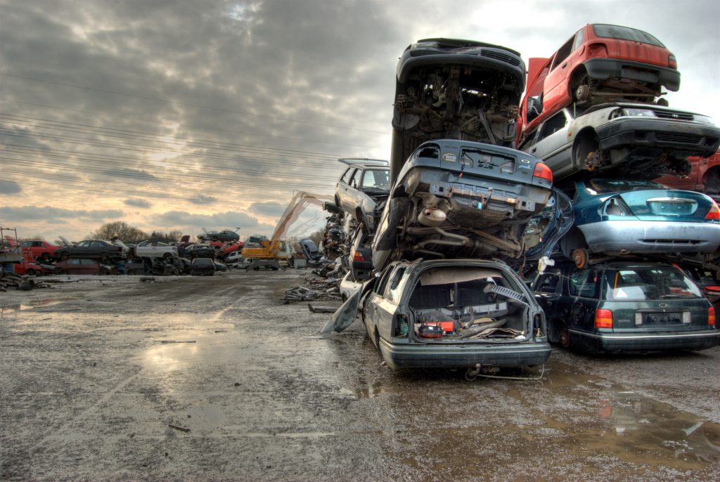 pile of wrecked cars in junkyard