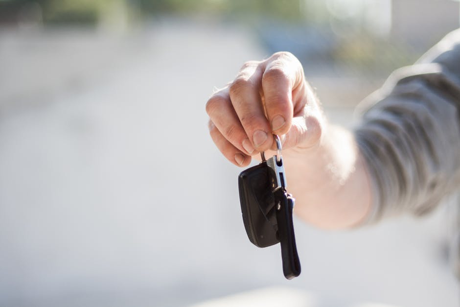 person holding car key