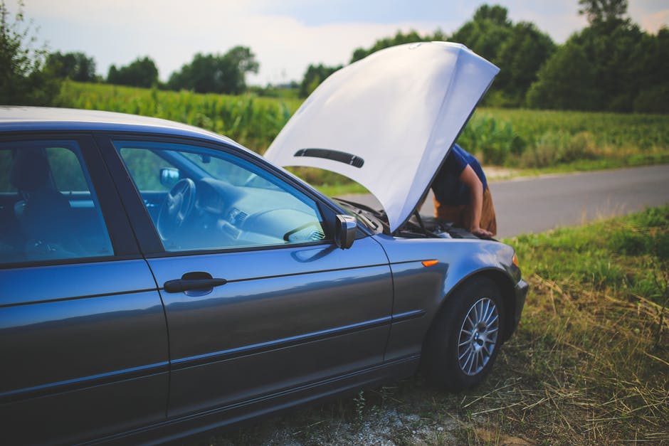 person with car that won't start