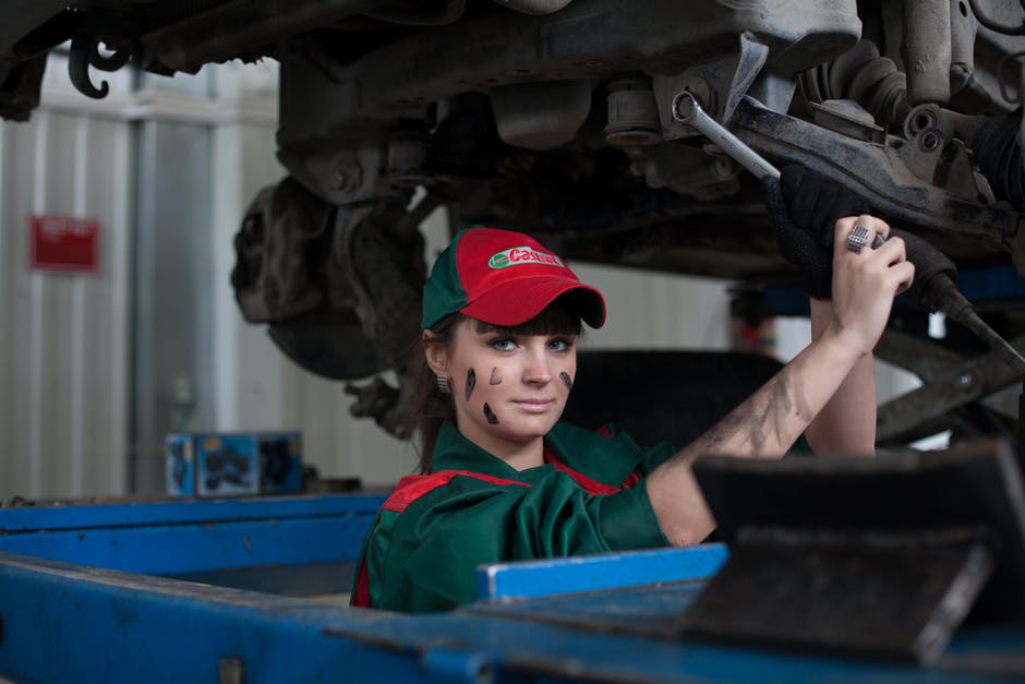 woman working on car