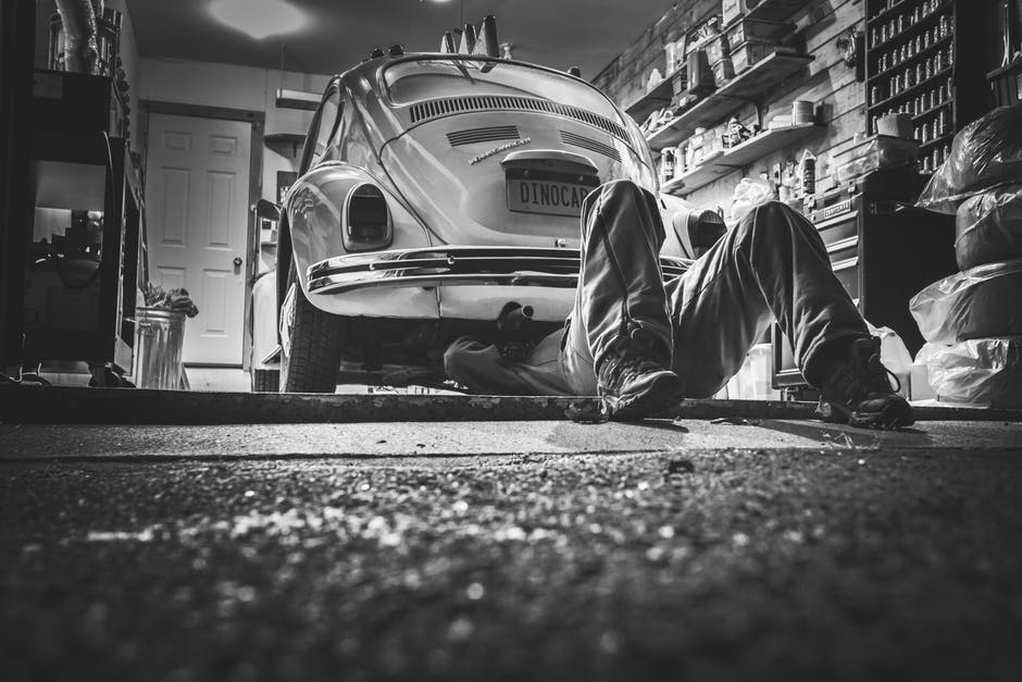 man doing auto repair in garage