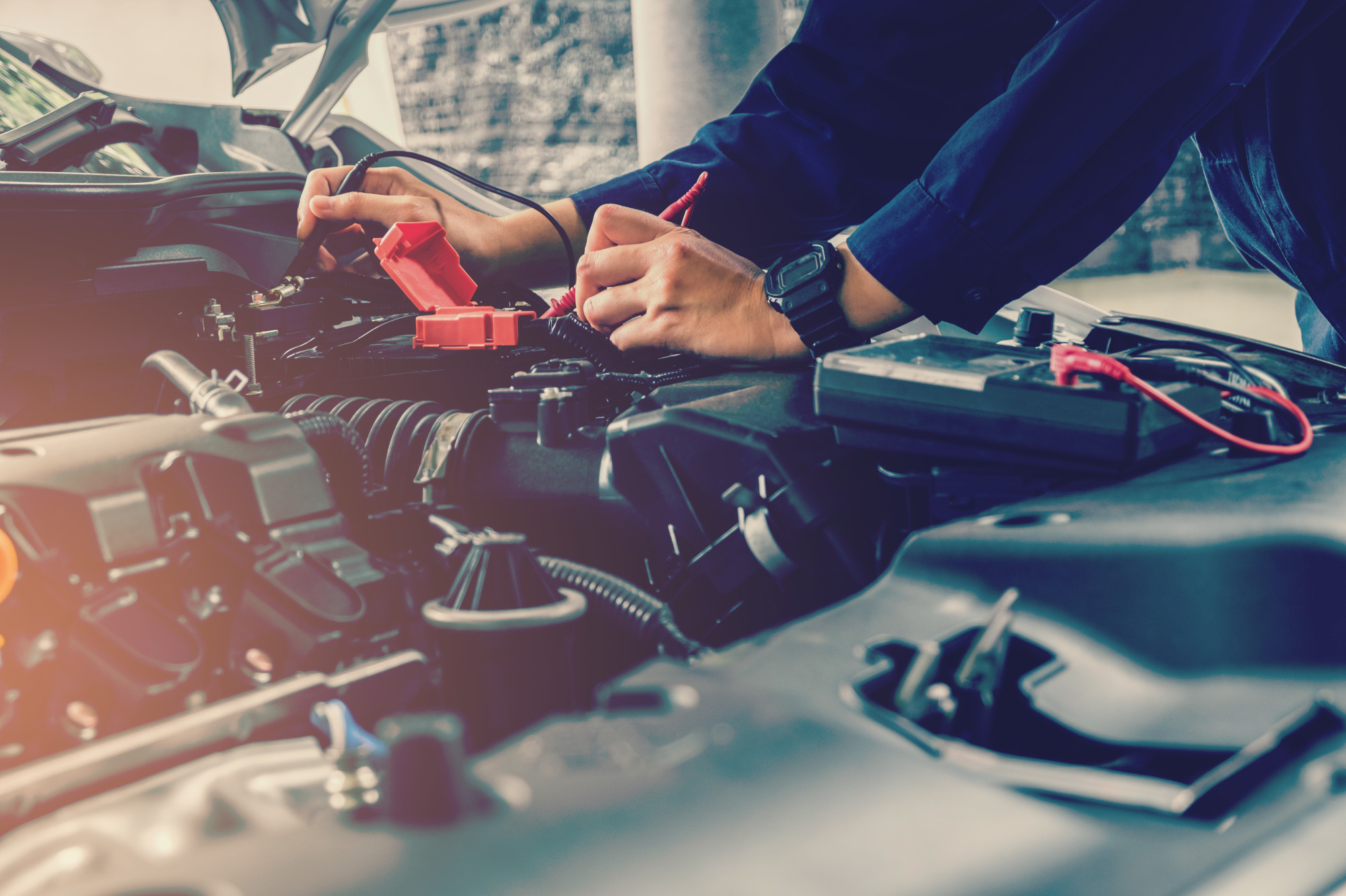 Person Checking a Car's Battery