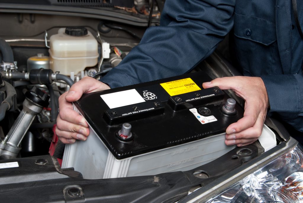 Mechanic Placing a Car Battery